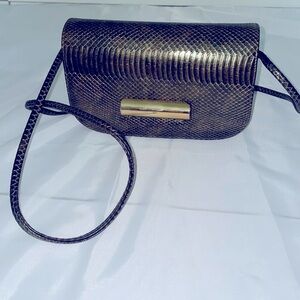 Metallic mini clutch handbag. Snake print